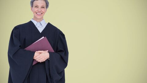 Eine Frau in Richterrobe mit einem Buch in der Hand