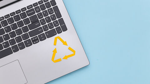 Die Ecke eines Laptops mit einem Wiederverwertungszeichen markiert