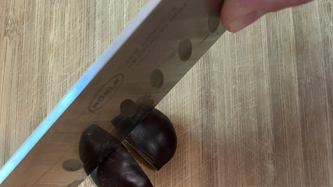 Rosskastanie wird mit einen großem Küchenmesser geviertelt Rosskastanie wird mit einen großem Küchenmesser geviertelt.